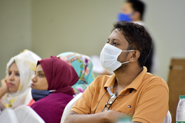 Delawar Hossain listens intently to a presentation on the EWARS platform.